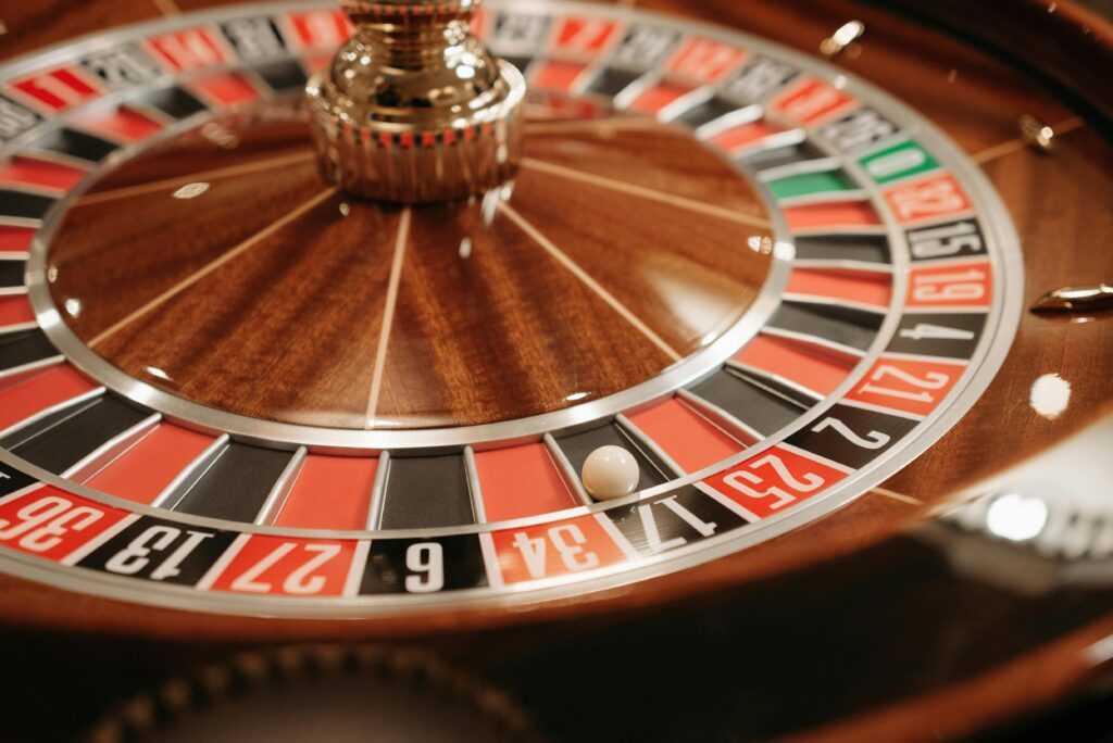 A detailed close-up of a spinning roulette wheel with the ball in play, capturing the essence of casino excitement and gambling.
