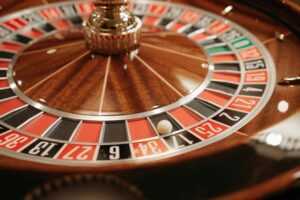 A detailed close-up of a spinning roulette wheel with the ball in play, capturing the essence of casino excitement and gambling.